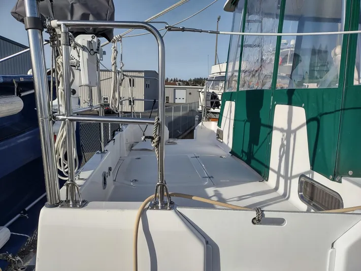 Journey Yacht Photos Pics 2002 Endeavour Trawlercat 36 deck with green canopy and metal railings.