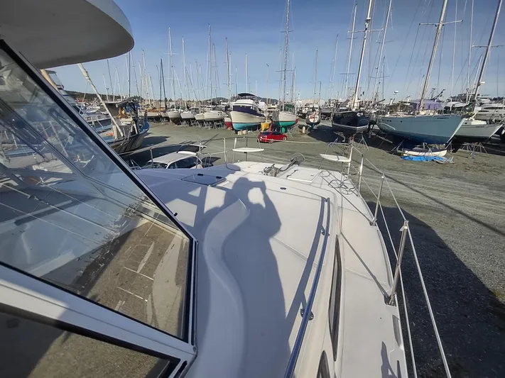 Journey Yacht Photos Pics 2002 Endeavour Trawlercat 36 on deck, surrounded by boats in a marina.