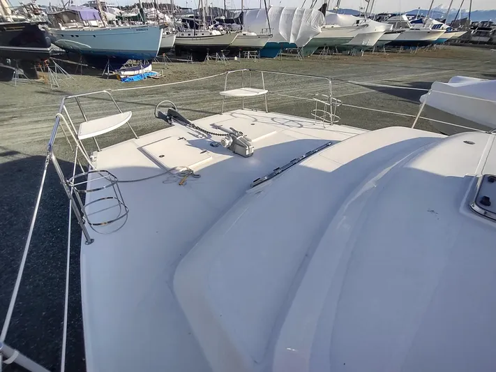 Journey Yacht Photos Pics 2002 Endeavour Trawlercat 36 on dry dock, surrounded by other boats.