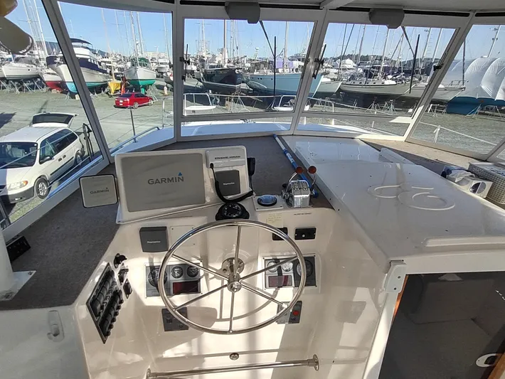 Journey Yacht Photos Pics Helm of 2002 Endeavour Trawlercat 36 with Garmin navigation system, docked in marina.
