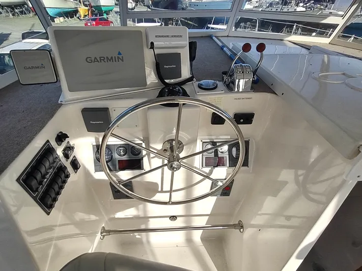 Journey Yacht Photos Pics Helm of 2002 Endeavour Trawlercat 36 with Garmin navigation system and steering wheel.