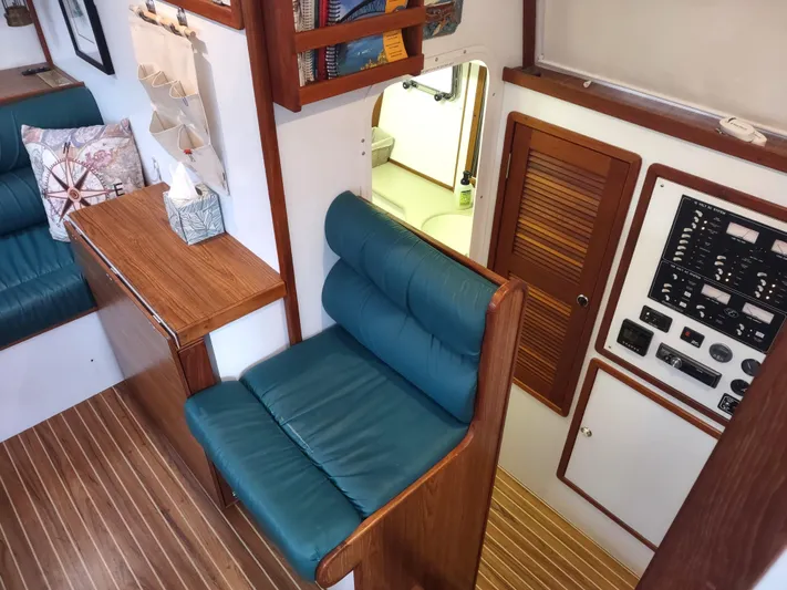 Journey Yacht Photos Pics Interior of 2002 Endeavour Trawlercat 36 with wood paneling and teal seating.