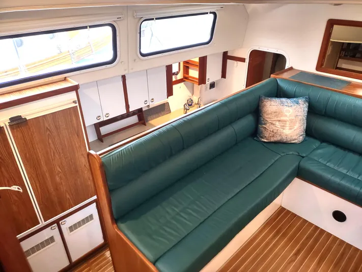 Journey Yacht Photos Pics Interior of 2002 Endeavour Trawlercat 36 with green seating and wood accents.