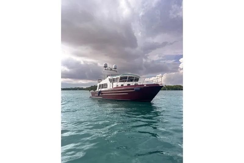 Oberwolf Yacht Photos Pics 2009 EagleCraft 47' Pilothouse boat on calm water under cloudy sky.