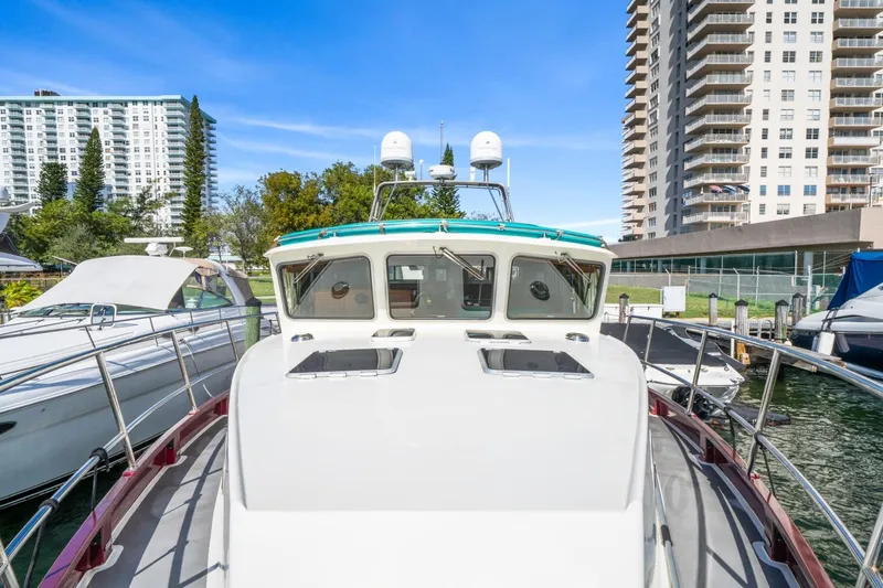 Oberwolf Yacht Photos Pics 2009 EagleCraft 47' Pilothouse yacht docked near high-rise buildings.