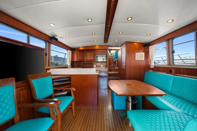 Oberwolf Yacht Photos Pics Interior of 2009 EagleCraft 47' Pilothouse with turquoise seating and wooden finishes.