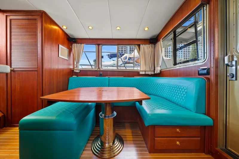 Oberwolf Yacht Photos Pics Luxurious 2009 EagleCraft 47' Pilothouse interior with teal seating and wooden accents.