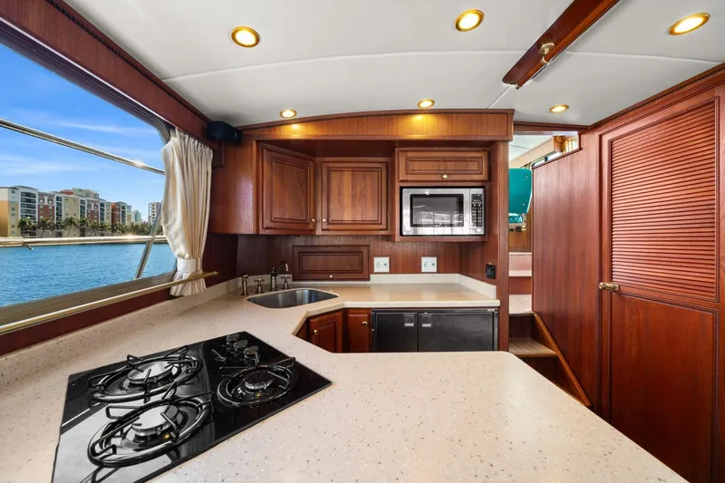 Oberwolf Yacht Photos Pics Luxurious kitchen interior of 2009 EagleCraft 47' Pilothouse yacht with wood cabinetry and ocean view.
