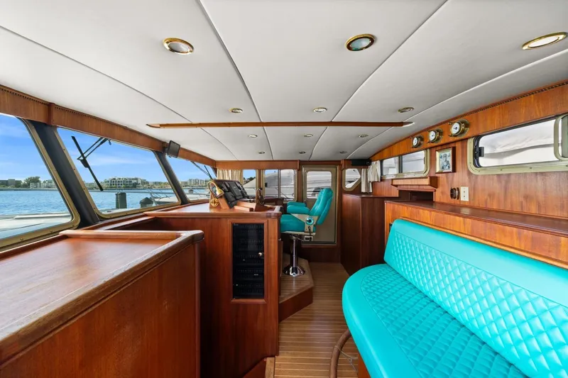 Oberwolf Yacht Photos Pics Interior of 2009 EagleCraft 47' Pilothouse with turquoise seating and wooden finishes.