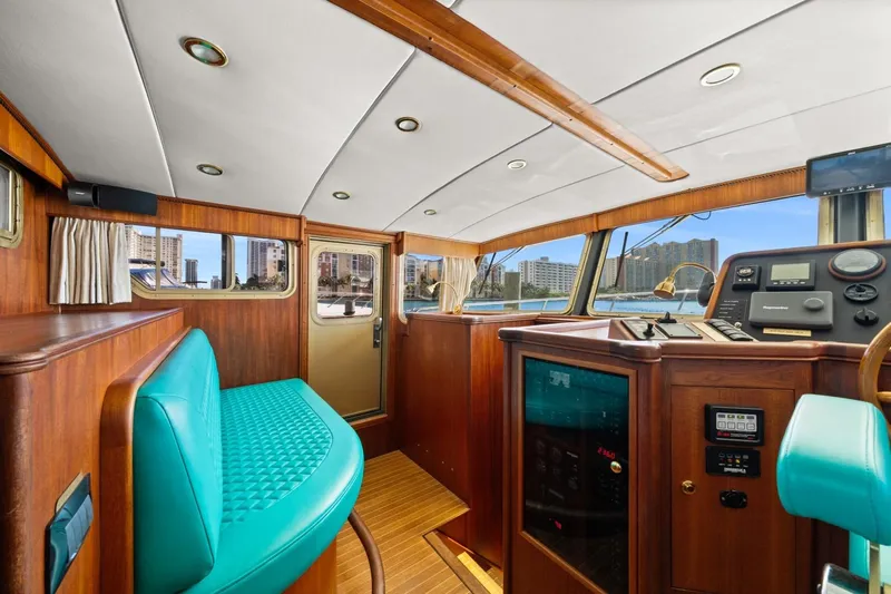 Oberwolf Yacht Photos Pics Interior of 2009 EagleCraft 47' Pilothouse with turquoise seating and wooden accents.