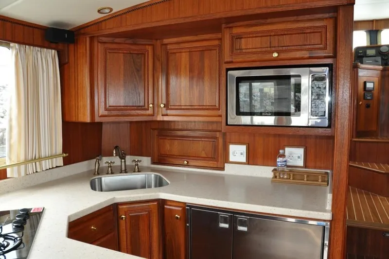 Oberwolf Yacht Photos Pics Luxurious wooden kitchen interior of 2009 EagleCraft 47' Pilothouse yacht with modern appliances.