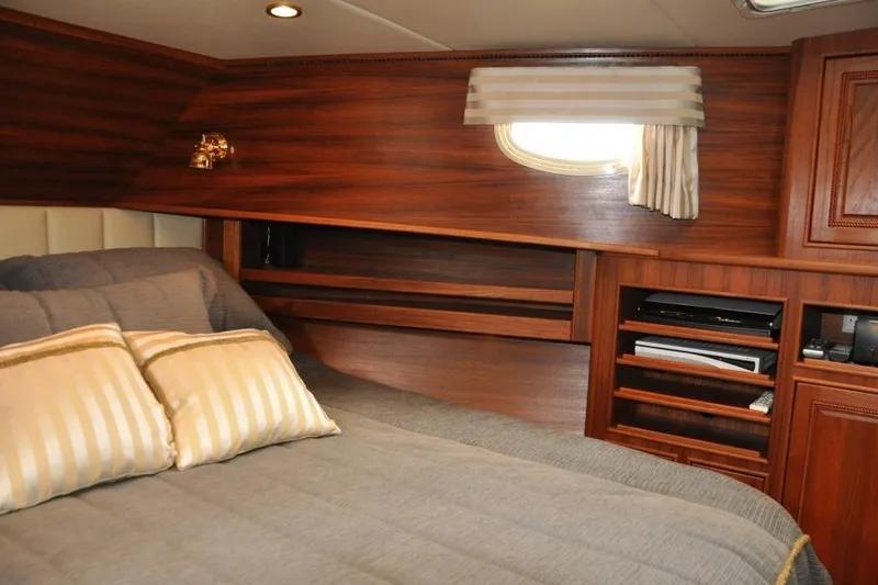 Oberwolf Yacht Photos Pics Luxurious cabin interior of 2009 EagleCraft 47' Pilothouse with wood paneling and cozy bedding.