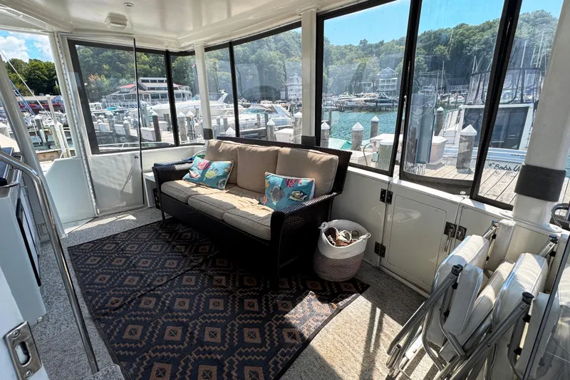  Yacht Photos Pics 1997 Carver 445 Aft Cabin Motor Yacht interior with sofa, pillows, and marina view.