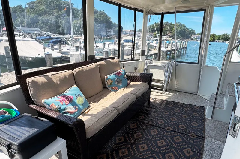  Yacht Photos Pics 1997 Carver 445 Aft Cabin Motor Yacht interior with cozy seating and marina view.