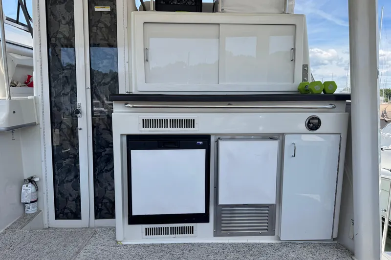  Yacht Photos Pics 1997 Carver 445 Aft Cabin Motor Yacht interior with kitchenette and storage cabinets.