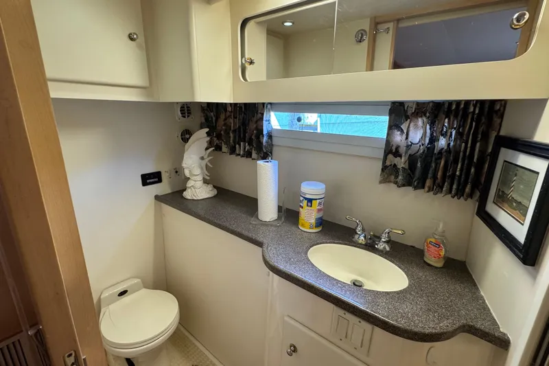  Yacht Photos Pics Bathroom interior of 1997 Carver 445 Aft Cabin Motor Yacht with sink and toilet.