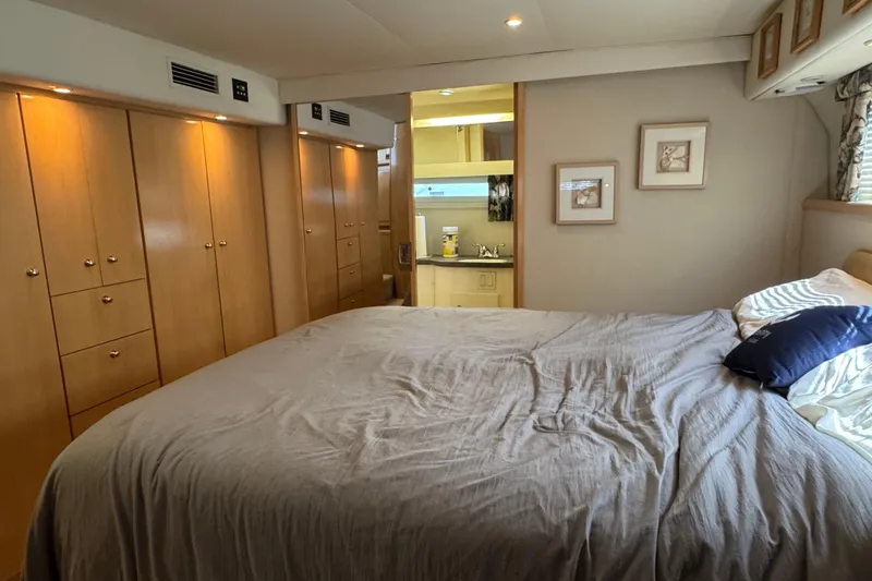  Yacht Photos Pics 1997 Carver 445 Aft Cabin Motor Yacht bedroom with wood cabinetry and ensuite bathroom.