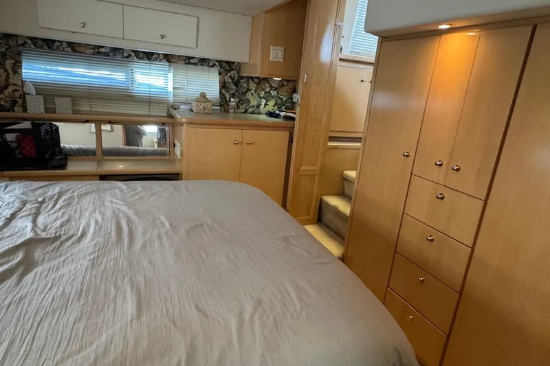  Yacht Photos Pics 1997 Carver 445 Aft Cabin Motor Yacht interior with wood cabinetry and cozy bedroom.