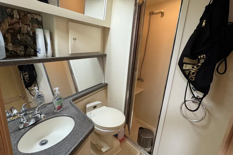  Yacht Photos Pics Bathroom interior of 1997 Carver 445 Aft Cabin Motor Yacht with sink, toilet, and shower.