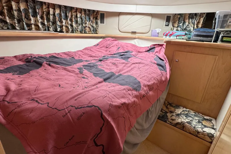  Yacht Photos Pics 1997 Carver 445 Aft Cabin Motor Yacht bedroom with map-themed bedding and storage.