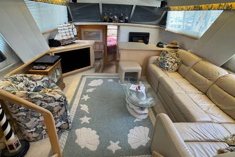  Yacht Photos Pics Luxurious interior of 1997 Carver 445 Aft Cabin Motor Yacht with plush seating and nautical decor.