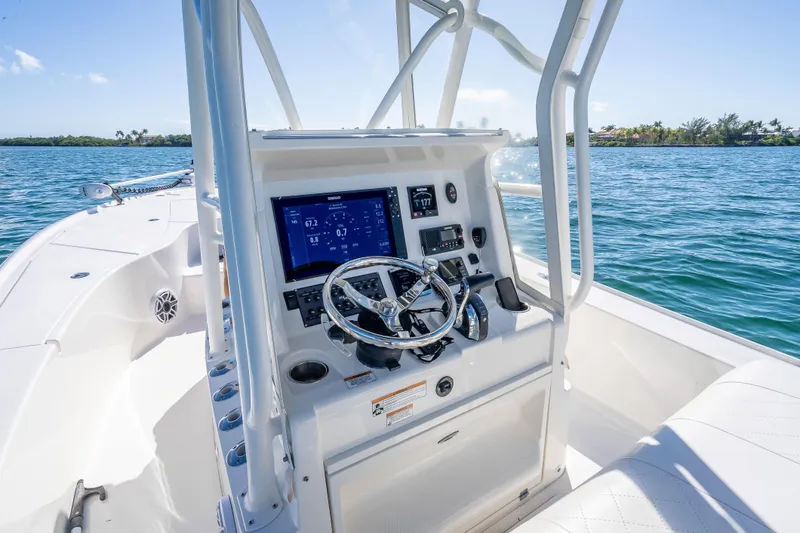  Yacht Photos Pics 2017 SeaVee 270Z boat console with steering wheel and navigation display on open water.