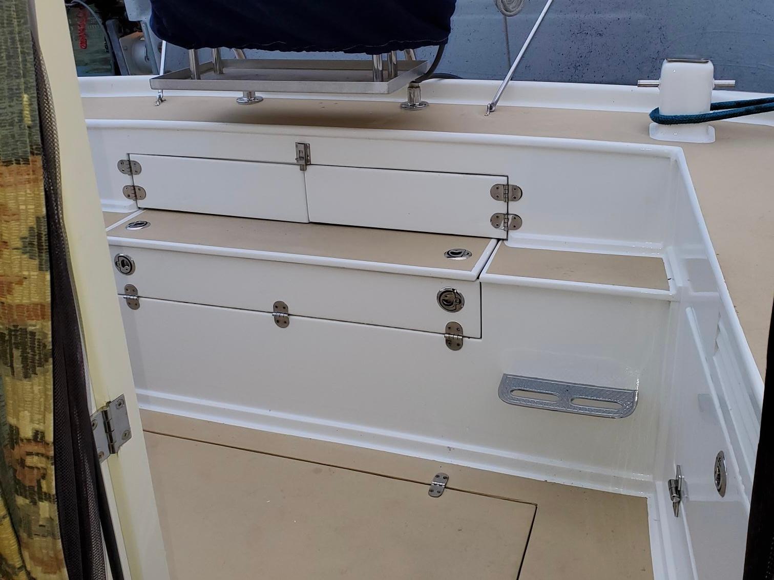 1970 Custom Tri-Cabin boat interior with white storage compartments and beige flooring.