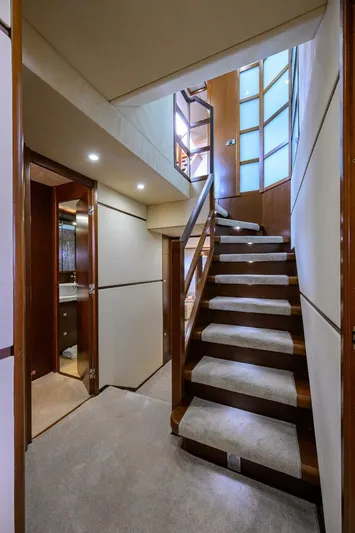 21 Sea Sands Yacht Photos Pics Interior staircase of 2009 Princess 95 yacht with modern design and wooden accents.