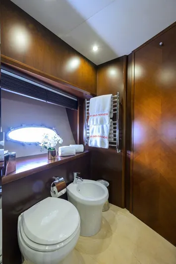 21 Sea Sands Yacht Photos Pics Luxurious bathroom in 2009 Princess 95 yacht with elegant wood paneling and modern fixtures.