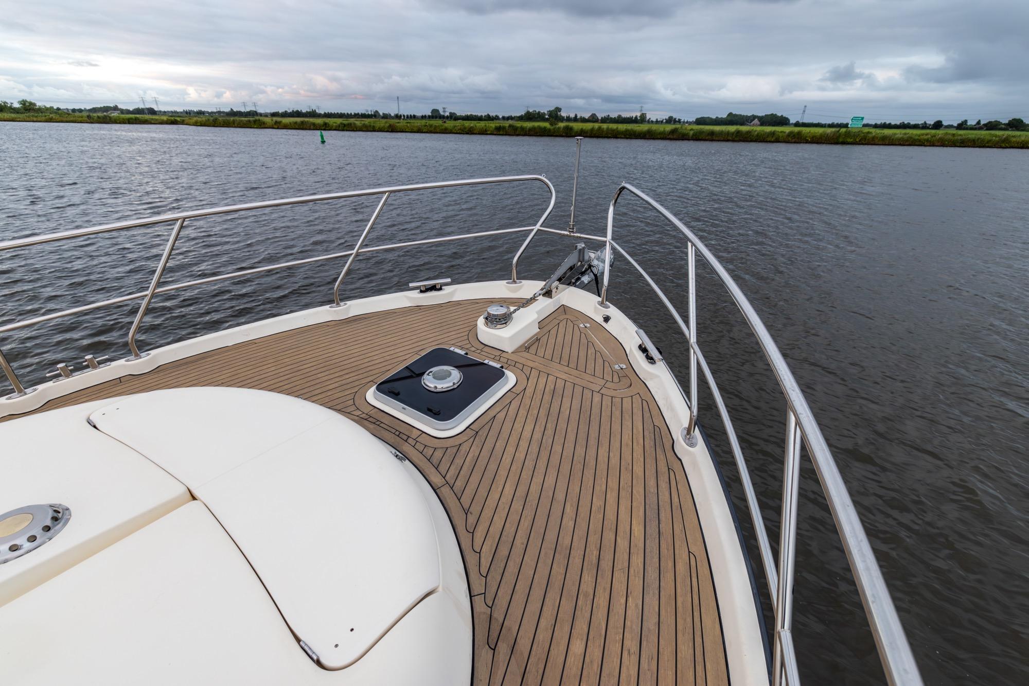 Bow view of 2001 Elling E3 Ultimate yacht on calm water under cloudy skies.