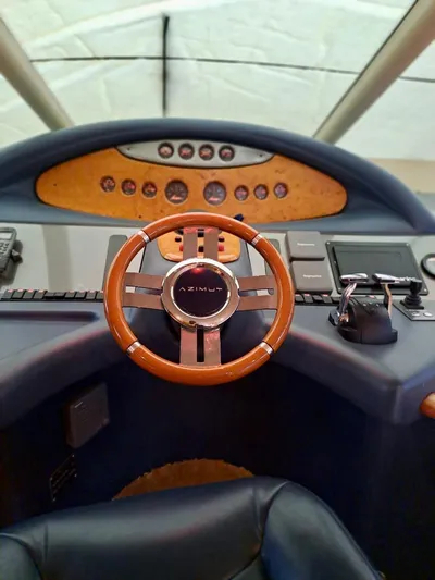  Yacht Photos Pics 2009 Azimut 62 yacht helm with wooden steering wheel and control panel.