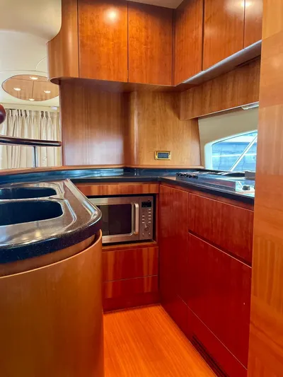  Yacht Photos Pics Luxurious 2009 Azimut 62 yacht kitchen with wood cabinetry and modern appliances.