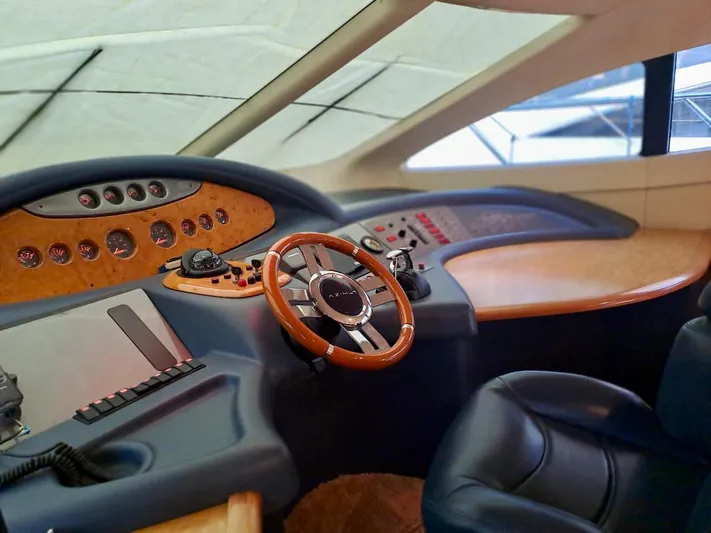  Yacht Photos Pics 2009 Azimut 62 yacht helm with wooden steering wheel and modern controls.