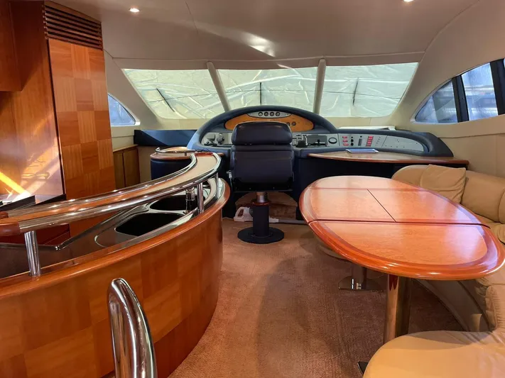  Yacht Photos Pics Luxurious interior of a 2009 Azimut 62 yacht with elegant wood finishes and modern helm.