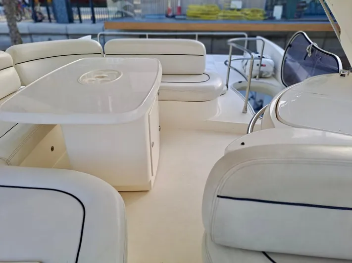  Yacht Photos Pics Luxurious 2009 Azimut 62 yacht interior with elegant white seating and table.