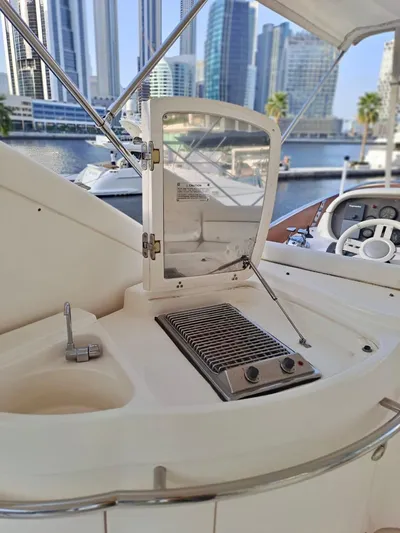  Yacht Photos Pics 2009 Azimut 62 yacht deck with grill, city skyline in background.