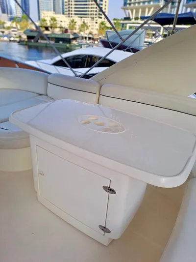 Yacht Photos Pics 2009 Azimut 62 yacht interior with sleek white seating and storage, docked in a marina.