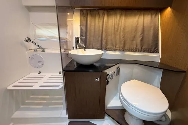  Yacht Photos Pics Modern bathroom in 2020 Jeanneau NC 1095 Fly yacht with sink, toilet, and shower.
