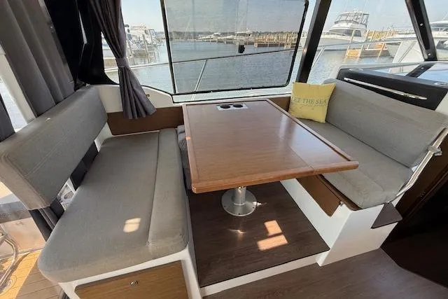  Yacht Photos Pics Interior of 2020 Jeanneau NC 1095 Fly with dining area and marina view.