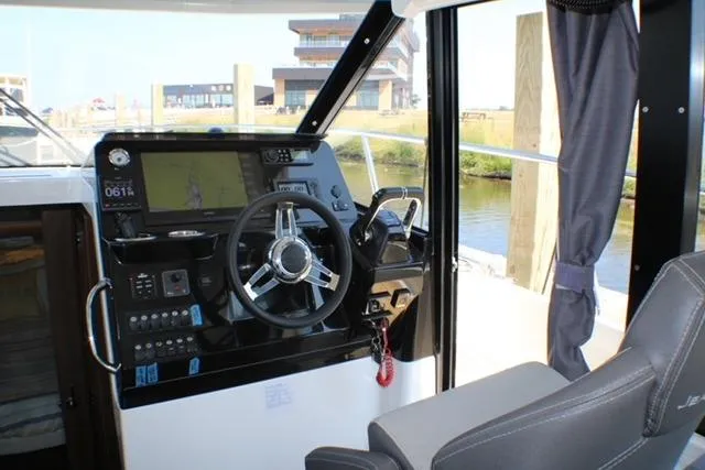  Yacht Photos Pics Interior helm of 2020 Jeanneau NC 1095 Fly boat with modern controls and steering wheel.