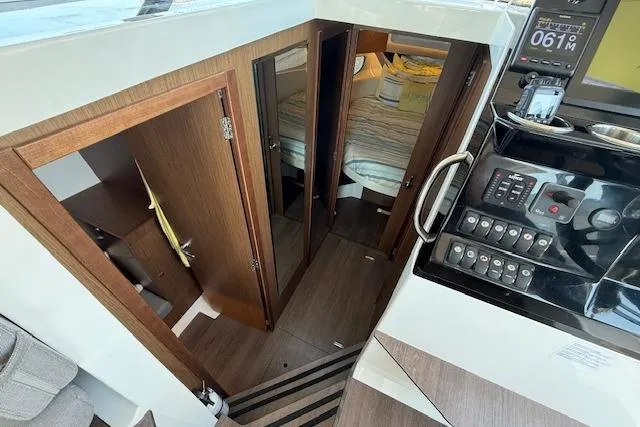  Yacht Photos Pics Interior view of 2020 Jeanneau NC 1095 Fly boat, featuring cabin and control panel.