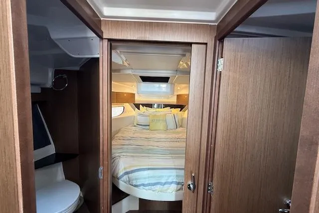  Yacht Photos Pics Interior of 2020 Jeanneau NC 1095 Fly, featuring cozy bedroom and modern bathroom.