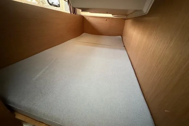  Yacht Photos Pics Interior cabin of 2020 Jeanneau NC 1095 Fly with wooden finish and cushioned bed.