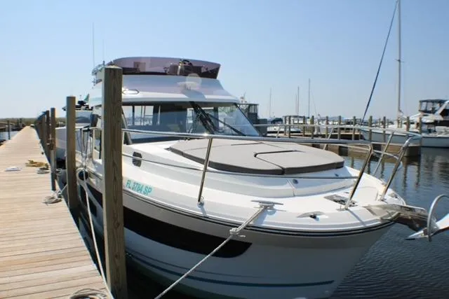  Yacht Photos Pics 2020 Jeanneau NC 1095 Fly yacht docked at marina, clear sky background.