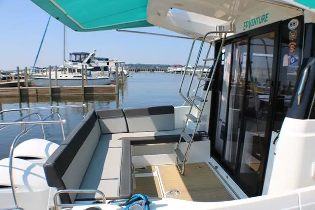  Yacht Photos Pics 2020 Jeanneau NC 1095 Fly yacht with spacious deck seating and marina view.