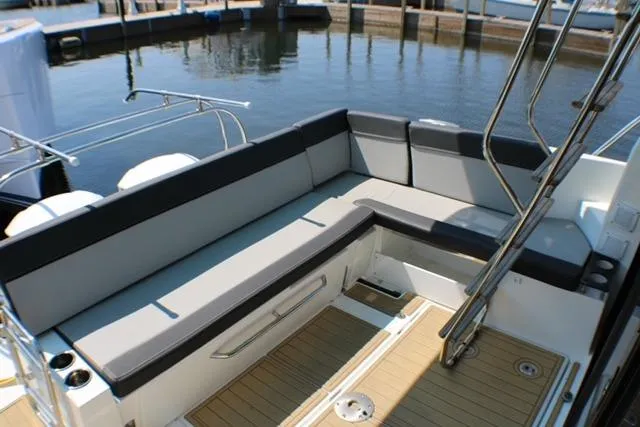  Yacht Photos Pics 2020 Jeanneau NC 1095 Fly boat with spacious seating and sleek design at the dock.