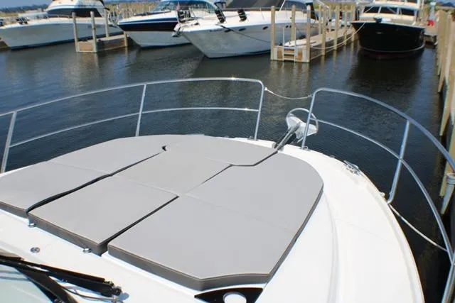  Yacht Photos Pics 2020 Jeanneau NC 1095 Fly yacht with sunpad, docked among other boats.