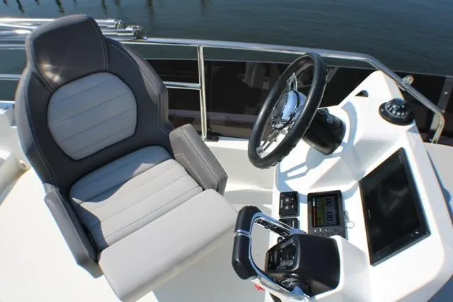  Yacht Photos Pics 2020 Jeanneau NC 1095 Fly helm with steering wheel and captain's chair.