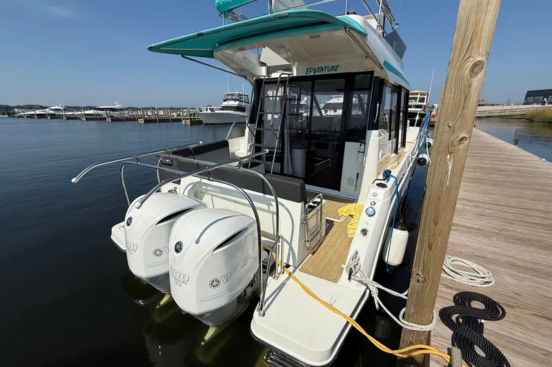  Yacht Photos Pics 2020 Jeanneau NC 1095 Fly docked, featuring dual Yamaha outboard engines.