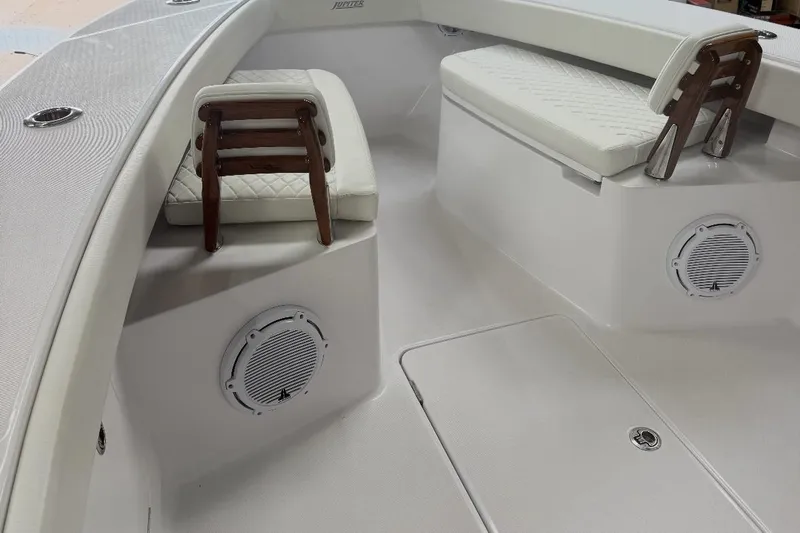  Yacht Photos Pics 2023 Jupiter 32 boat interior with cushioned seating and built-in speakers.